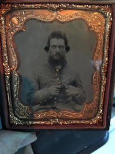 tin image of confederate soldier with weapons